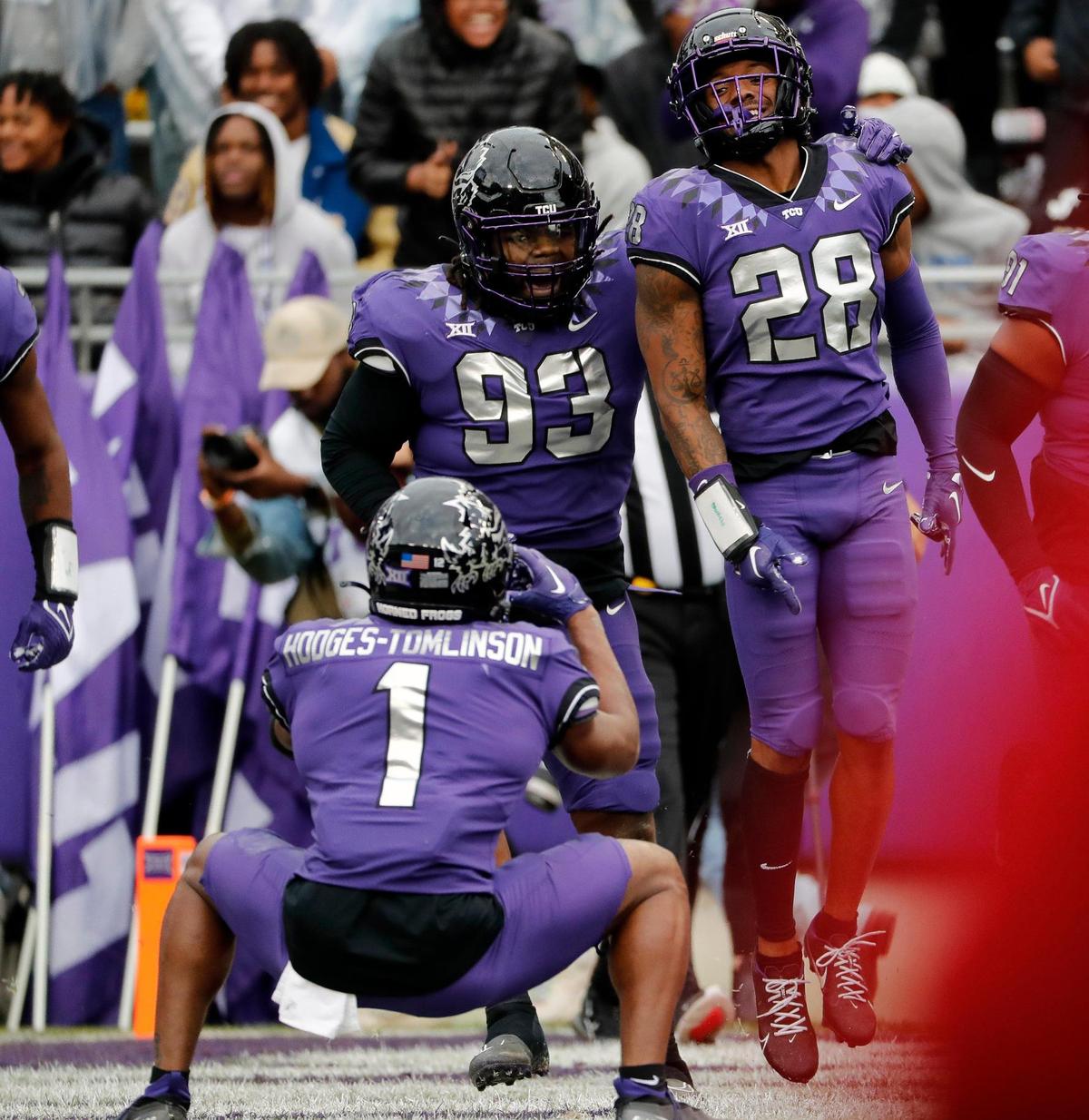 TCU defensive lineman George Ellis III (93), safety Millard Bradford (28) and cornerback Tre’Vius Hodges-Tomlinson (1) celebrates Bradford’s pick six as Hodges-Tomlinson imitates taking a picture in the first half of a NCAA football game at Amon G. Carter Stadium in Fort Worth, Texas, Saturday, Nov. 26, 2022. TCU led 34-7 at the half. (Special to the Star-Telegram Bob Booth)