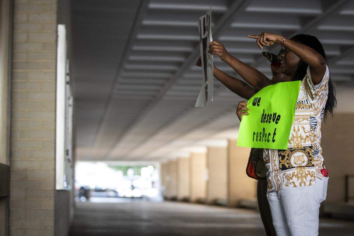 Protesters hold up signs facing into the windows of City Hall Tuesday, Oct. 15, 2019, in downtown Fort Worth.