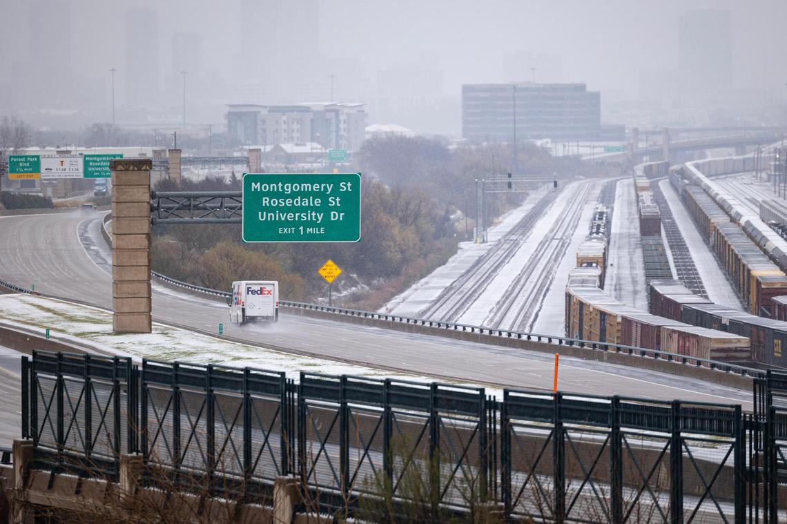 Snow covers the cargo trains and railroad behind the Chisholm Trail Tollway in Fort Worth on Thursday, Jan. 9, 2025.