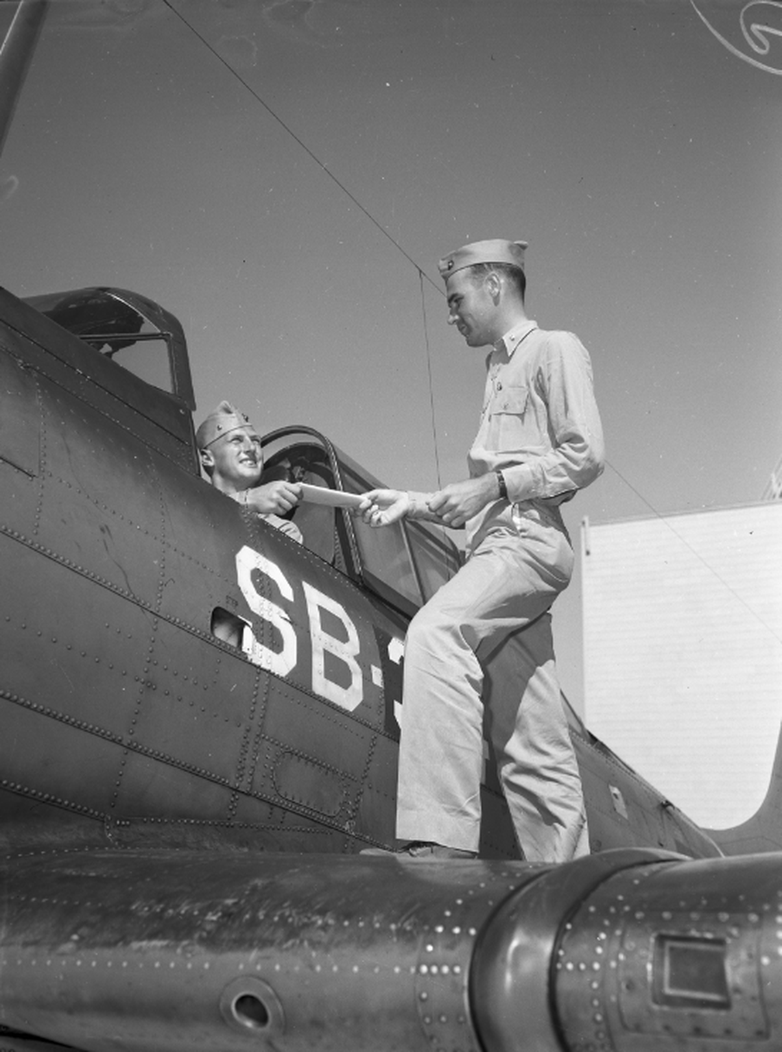 Marine Air Base at Eagle Mount Lake. In the plane, Major Robert Tucker receives target orders from Major Robert J. Bear.