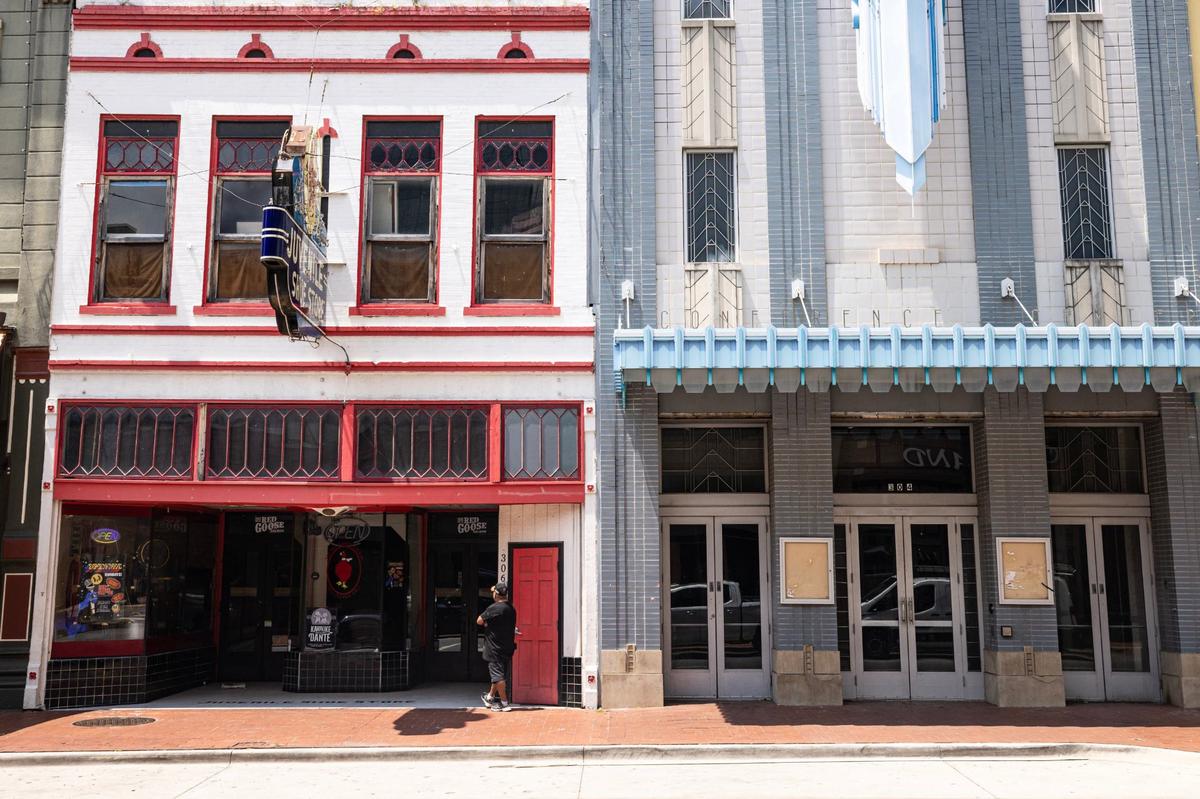 A man waits outside of the Red Goose Salon on Houston Street in downtown Fort Worth on Wednesday, July 24, 2024.