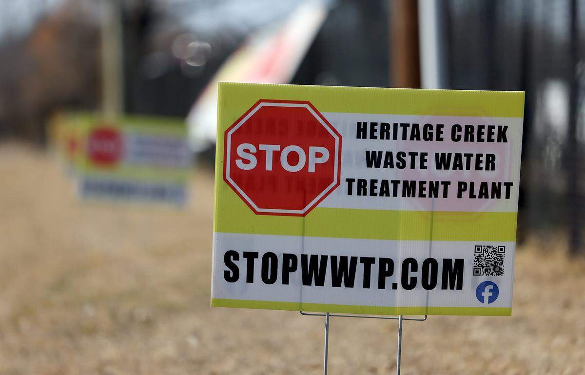 Lawn signs show opposition to a privately owned wastewater treatment facility for a proposed mobile home community that's slated to go on a vacant 65-acre lot in a Burleson neighborhood on Thursday, Jan. 29, 2026.