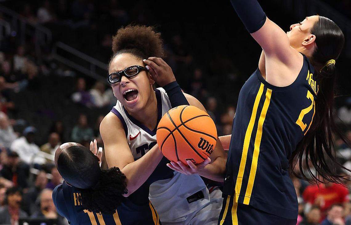 KANSAS CITY, MISSOURI - MARCH 08: Olivia Miles #5 of the TCU Horned Frogs drives to the basket as Jordan Harrison #10 and Riley Makalusky #21 of the West Virginia Mountaineers defend during the championship game of the 2026 Big 12 Women's Tournament at T-Mobile Center on March 08, 2026 in Kansas City, Missouri. (Photo by Jamie Squire/Getty Images)