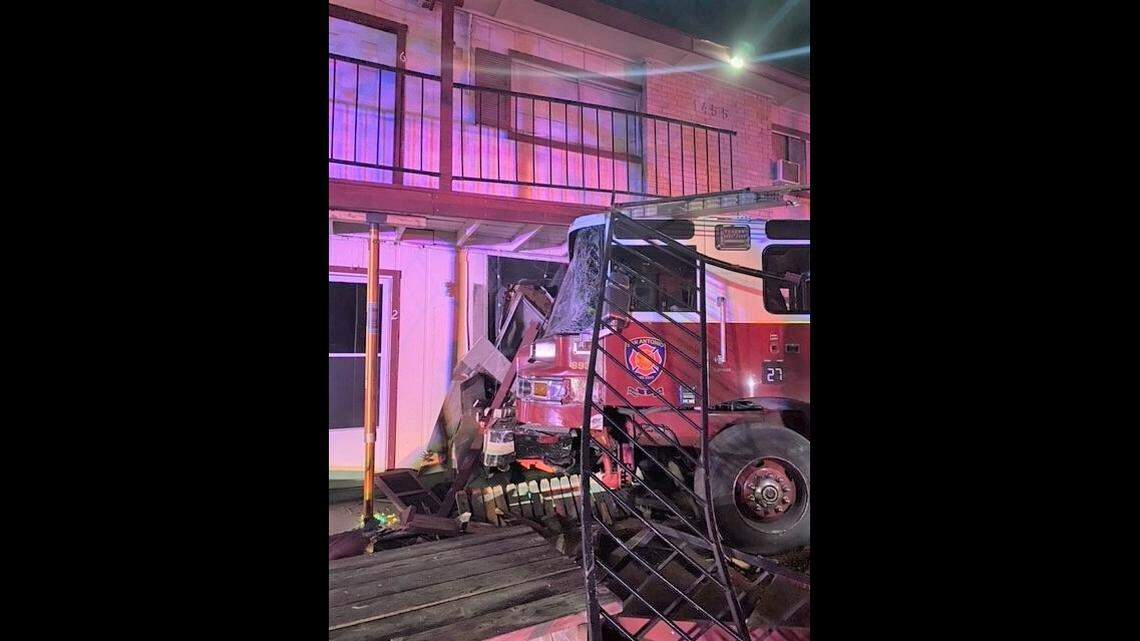 This fire truck was forced into an apartment building after it was struck by a “fast moving vehicle,” officials say.