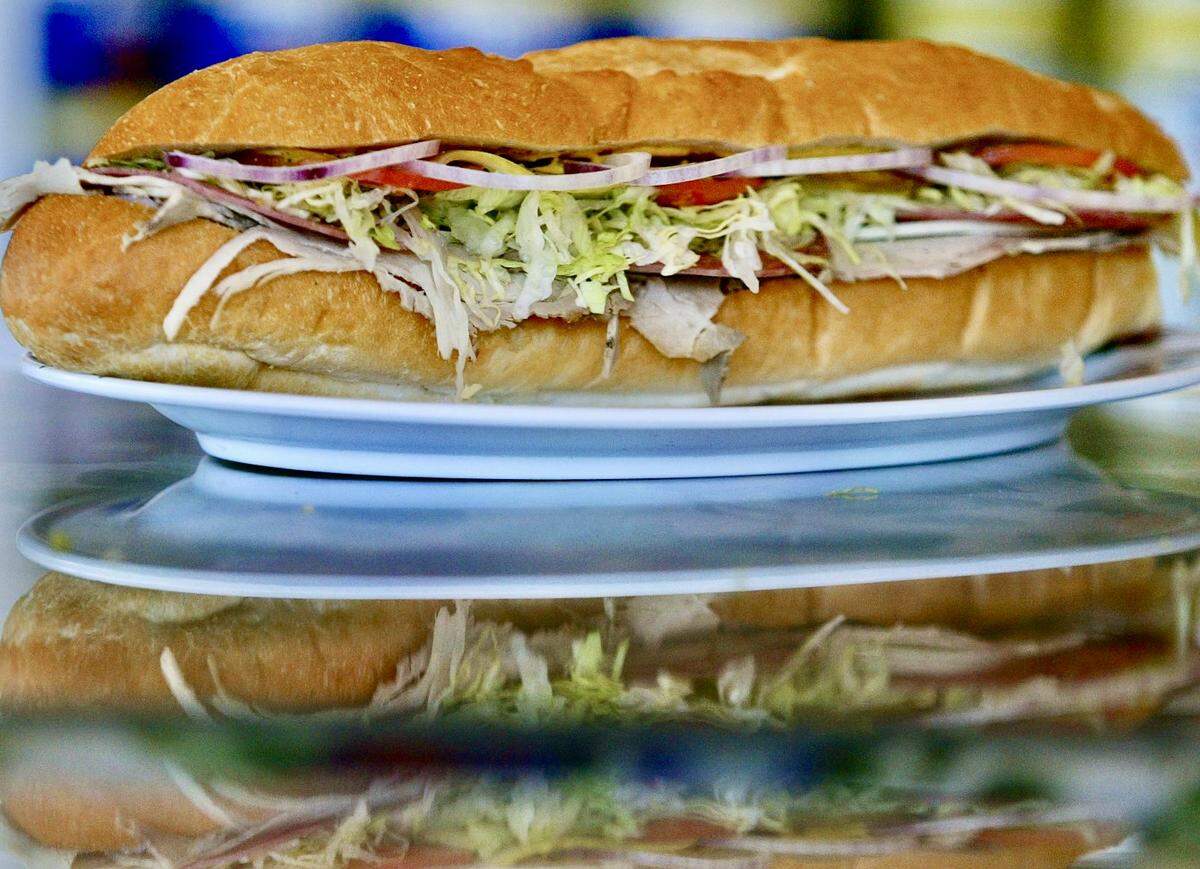 The Deluxe pressed Cuban sandwich of ham, pork, salami and cheese with lettuce and tomato was one of the popular sandwiches at Cuco's Sandwich Shop in North Richland Hills, Texas, as seen March 12, 2005.