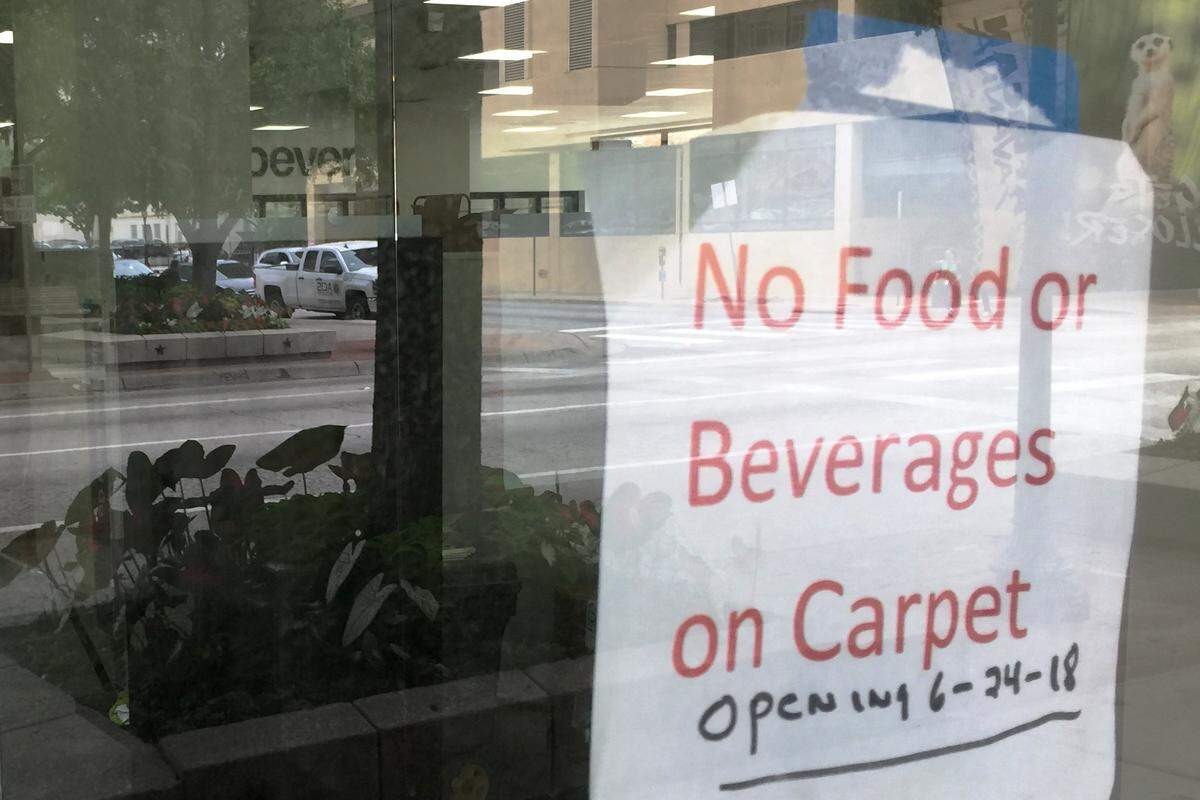 A sign outside the new CVS Pharmacy in downtown Fort Worth notifies passers-by that the store is scheduled to open June 24.