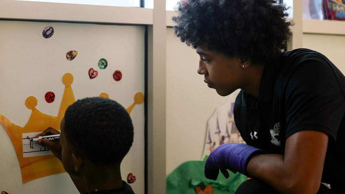 Josiah Hall, 16, a junior at Ben Barber Innovation Academy, helps pre-K student Saint Bishop write his name while interning at Jandrucko Early Learners Academy on Thursday, Nov. 6, 2025.