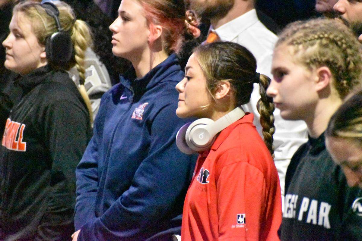 Arlington Martin wrestler Camille Rainey stands alongside competitors at the UIL Texas high school wrestling state tournament in Cypress, Texas, on Saturday, Feb. 14, 2026.