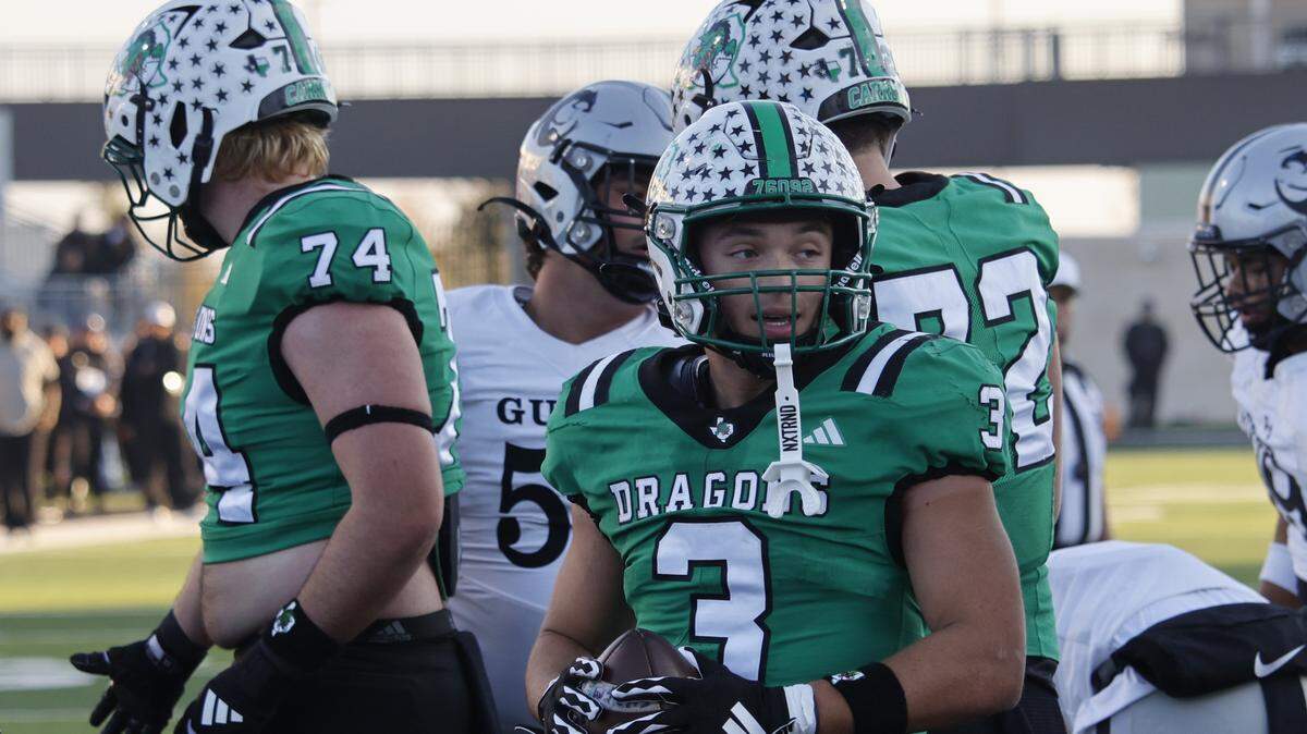 Southlake Carroll running back Davis Penn (3) looks for an official to give the ball to after scoring against Denton Ryan during the second half of a UIL Class 6A Division II Quarterfinal on Saturday Dec. 06, 2025 at Crowley ISD Multi-Purpose Stadium in Fort Worth, Texas.