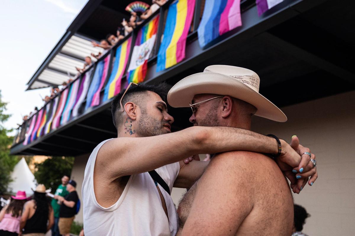 Partners Aaron Keller, left, and Chet Atkins dance together to the music being performed on stage at the Arlington Pride event at Levitt Pavilion in Arlington on Saturday, June 8, 2024.
