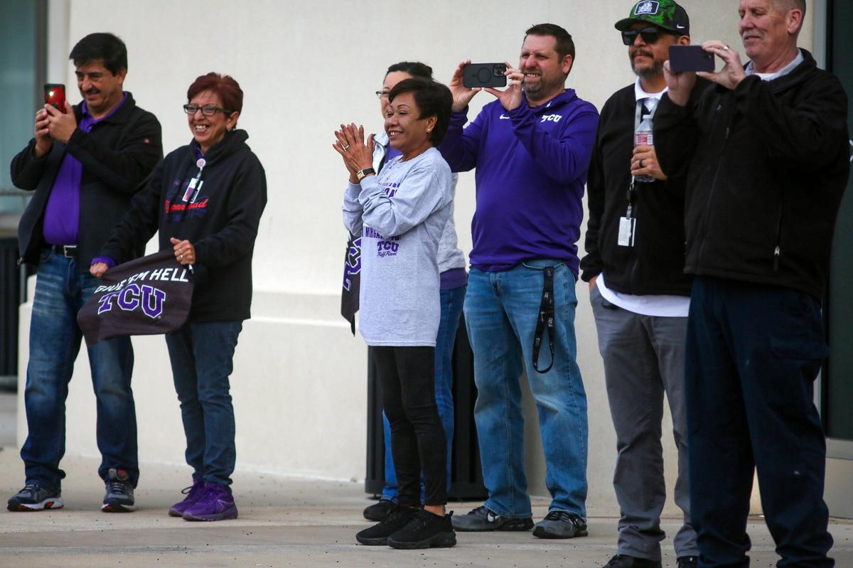 A huddle of fans cheer on Sonny Dykes as he leaves with his team for the College Football Championships, outside of the Amon G. Carter Stadium in Fort Worth on Friday, Jan. 6, 2023. As the buses left, more fans lined nearby streets to cheer them on.