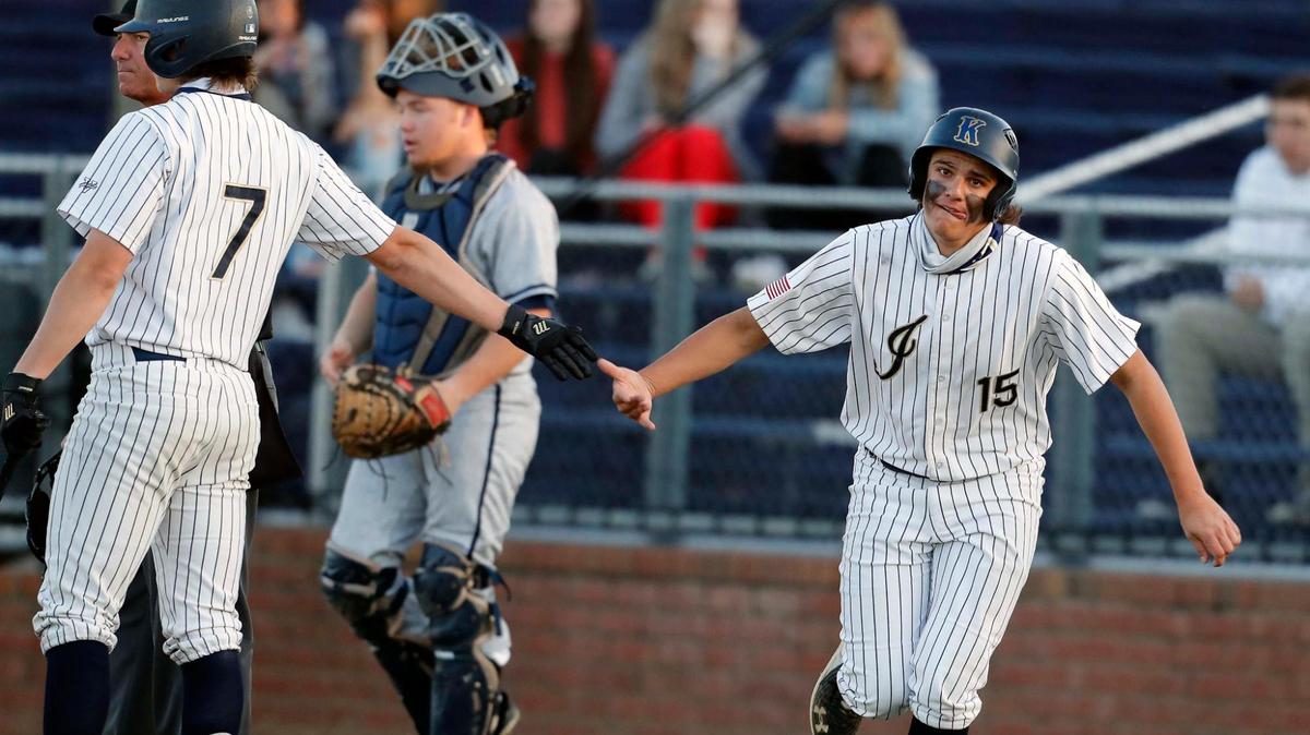 Keller second baseman Mike Dahalo (15) is congratulated by right fielder Clayton Thomas (7) after Dahalo tied the game in the first inning during a 4-6A high school baseball game at Keller High School Baseball Field in Keller, Texas, Tuesday, March 23, 2021. Keller defeated Eaton 13-3 in four and 1/2 innings. (Special to the Star-Telegram Bob Booth)