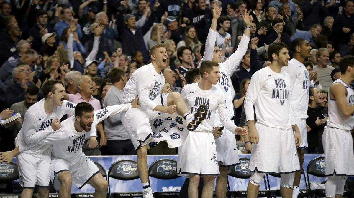 Villanova players celebrate after a a basket against Texas Tech during the second half of an NCAA men's college basketball tournament regional final, Sunday, March 25, 2018, in Boston.