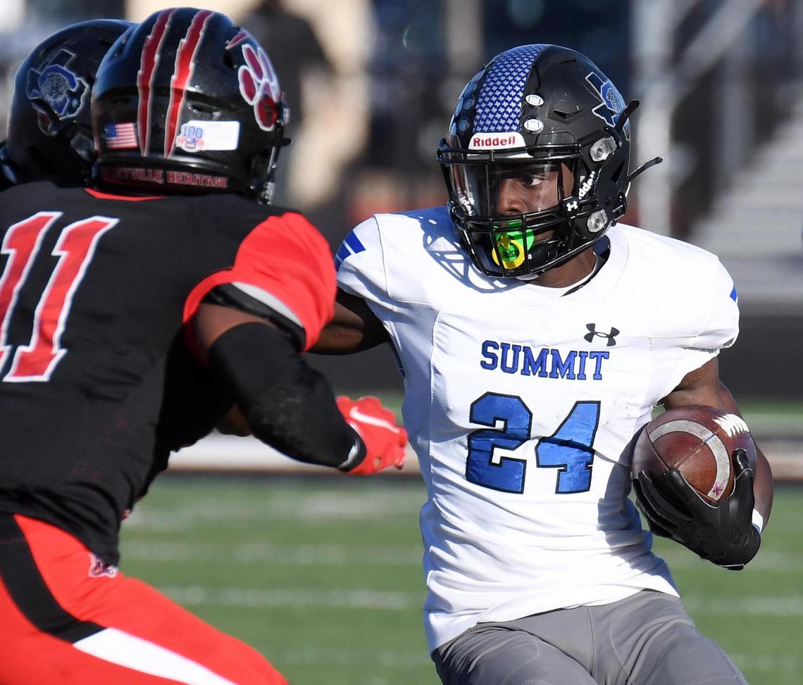 Mansfield Summit’s Keon Hobbs, right, rushes for a first down as Colleyville Heritage’s Joshua Dobbins makes the stop in the second quarter of their Division 1-5A Regional Round Play-off football game Saturday, December 26, 2020 at Bearcat Stadium in Aledo, Texas. Summit went on to win 34-31. Special/Bob Haynes