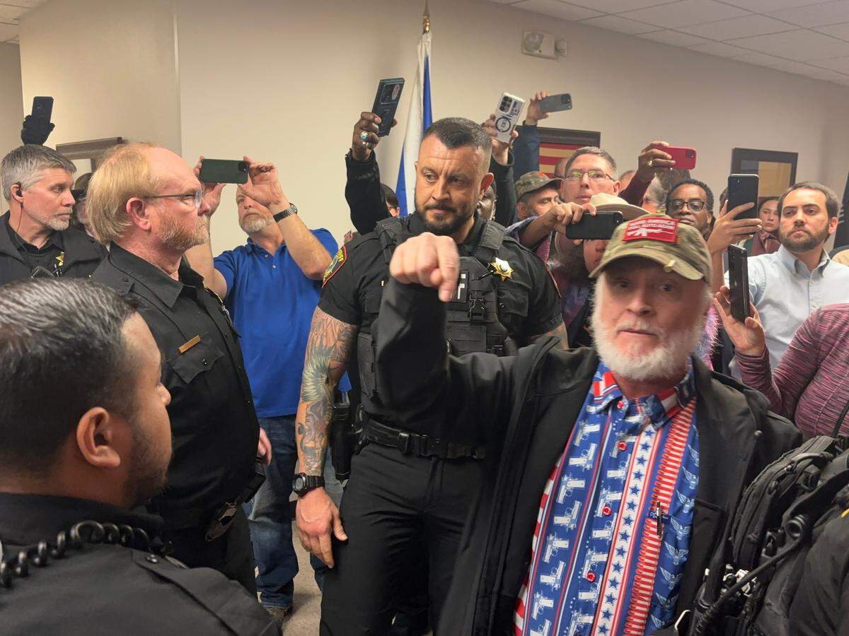 Christopher J. Grisham, a criminal defense and civil rights lawyer from Temple, argues with Tarrant County Sheriff’s Office deputies over his right to carry a gun in commissioners court on Tuesday, Jan. 14, 2025. Grisham was part of a group of conservative activists who came to demand justice for Mason Yancy, who died in the Tarrant County jail in December 2024, and call for the resignation of Sheriff Bill Waybourn.