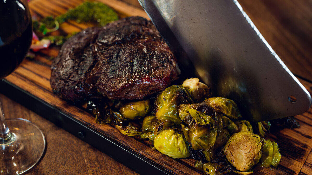 The menu at STIRR features a ribeye steak with Brussels sprouts.