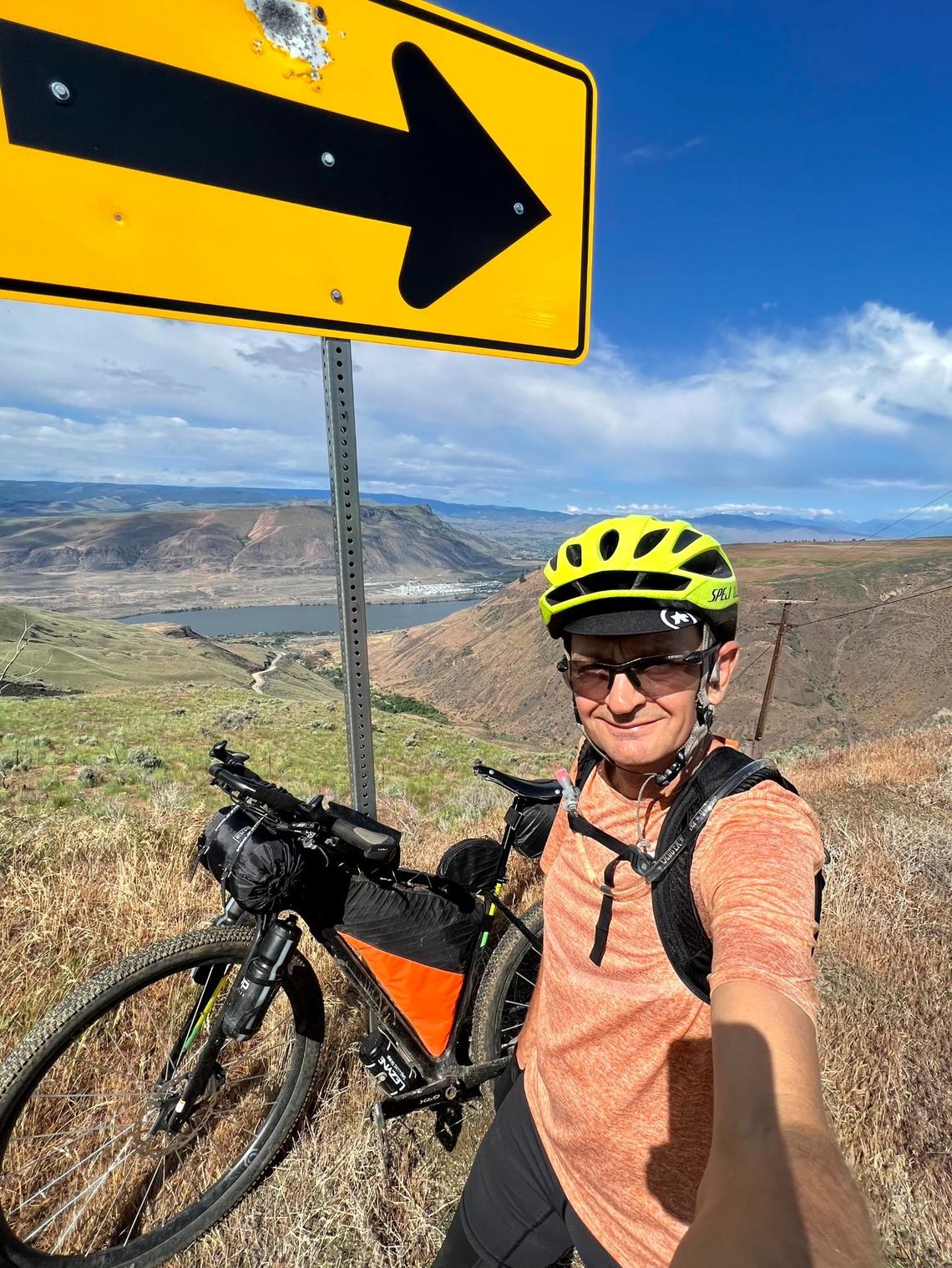 Rhea Wallace poses for a self portrait on a desolate stretch of his cross-state adventure.
