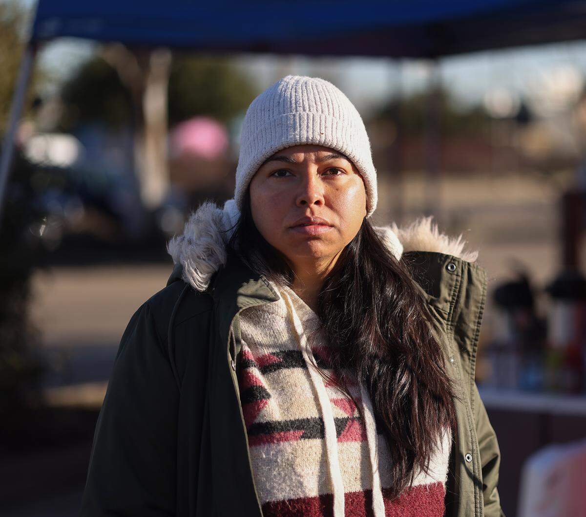 Community organizer Sandra Avalos stands outside tents that make up a respite center for immigrants with appointments and their family members at the U.S. Immigration and and Customs Enforcement field office in Dallas on Friday, Jan. 16, 2026. Avalos is at the tents every morning to recommend those with appointments sign a  ‘privacy waiver’ – an ICE form that allows a person to share their personal information with a specified third party.