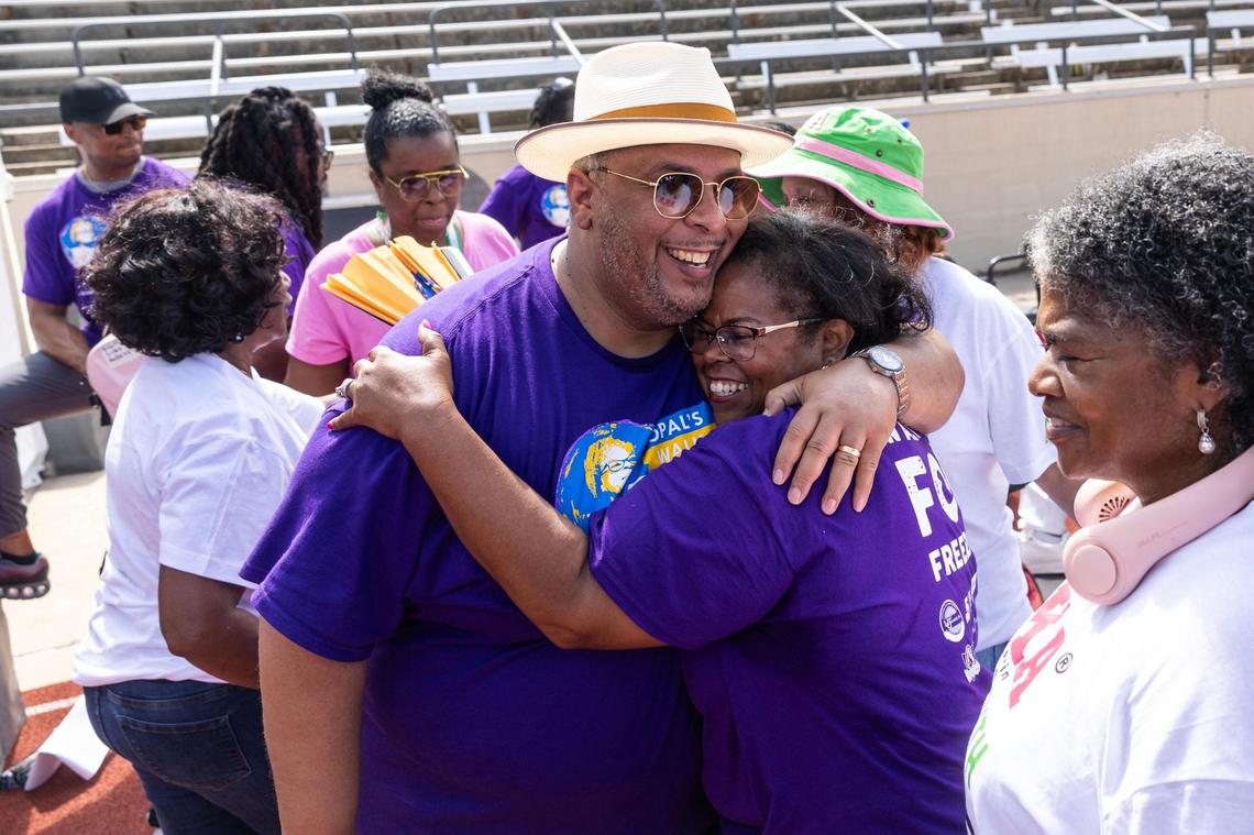 Roderick Miles Jr., the Tarrant County Commissioner of Precinct 1, hugs Dione Sims, the granddaughter of Opal Lee, following the Opal Lee Walk for Freedom at Farrington Field in Fort Worth on Thursday, June 19, 2025. Lee was not able to participate in this years walk due to health concerns.