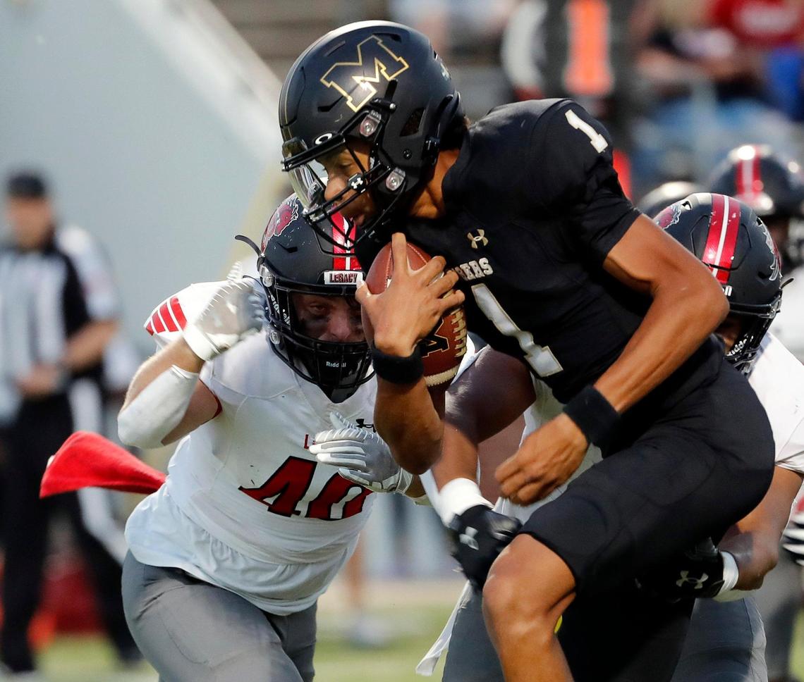 Mansfield quarterback Sergio Kennedy (1) attempts to avoid the tackle of Legacy linebacker Jonah Hillis in the first half of a high school football game at Newsom Stadium in Mansfield, Texas, Friday, Sept. 16, 2022. Mansfield led Legacy 16-6 at the half. (Special to the Star-Telegram Bob Booth)