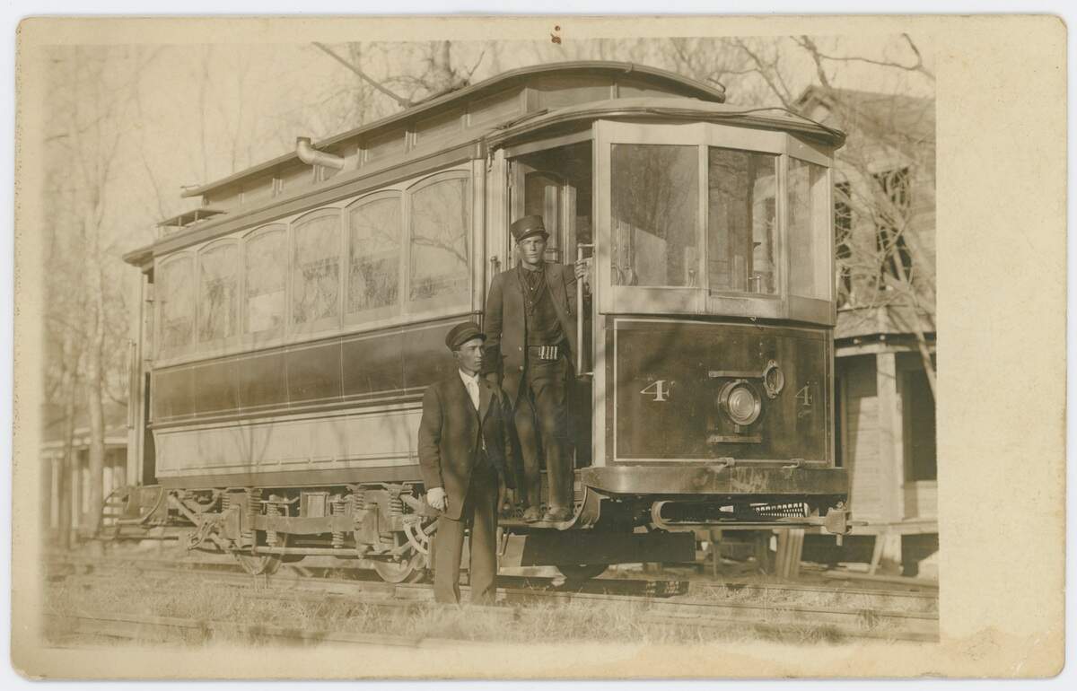 Streetcar conductor Frank Pierce, on the steps, with an unidentified motorman – or driver – in a residential area of Fort Worth about 1904-1906.