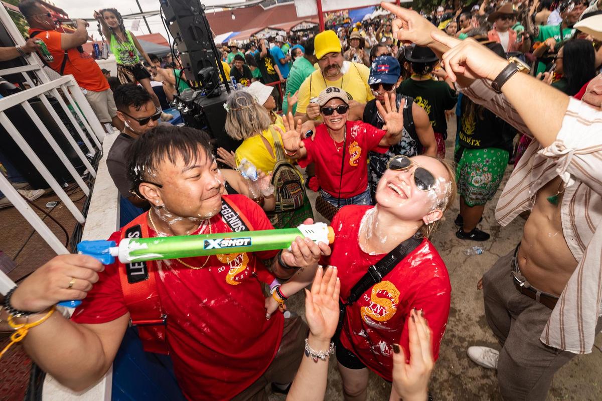 Festival attendees dance and party at the main live music stage on the third day of the Lao New Year festival at Wat Lao Thepnimith Temple in Saginaw on Sunday, April 27, 2025.