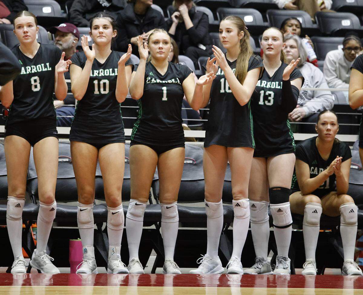 The Southlake Carroll Dragons celebrate a point against Austin during the third set.