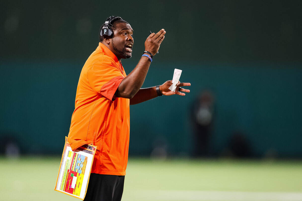 Arlington Bowie head coach Joseph Sam yells toward his team on the field in a bi-district playoff game at Choctaw Stadium in Arlington, Texas on Nov. 14, 2025.