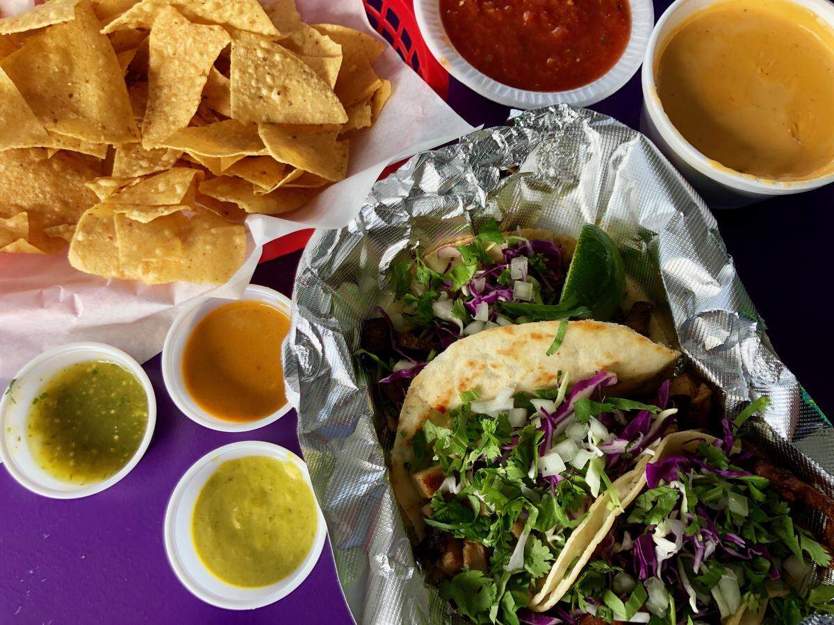 A street tacos plate — pastor on corn, brisket on flour, chicken fajita on flour — at Sammy’s on the Lake.