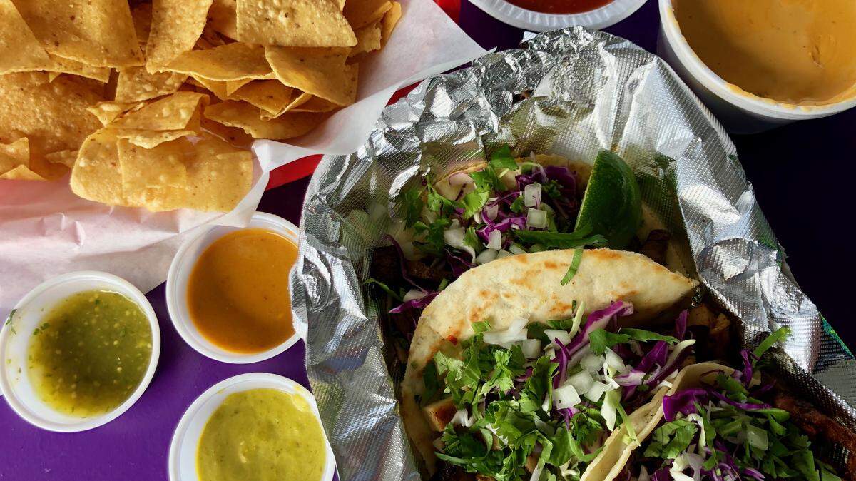 A street tacos plate — pastor on corn, brisket on flour, chicken fajita on flour — at Sammy’s on the Lake.