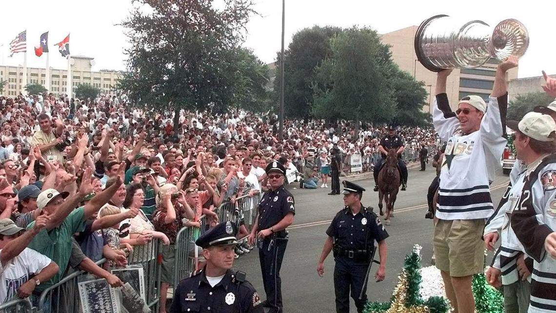 Dallas Stars Most Valuable Player Joe Nieuwendyk, right, shows off the Stanley Cup to the crowd during a victory parade in Downtown Dallas Monday, June 21, 1999. (AP Photo/LM Otero)