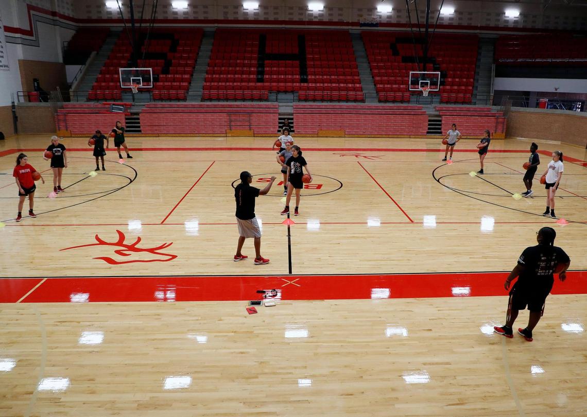 Lady Elks head basketball coach Olivia Pyburn, in the center, works with the team during workouts at Burleson High School in Burleson, Monday, June 08, 2020. Football, boys and girls basketball and volleyball worked out for the first time Monday. Most of the days workouts were instructional on procedures and how to social distance to stay healthy. (Special to the Star-Telegram Bob Booth)
