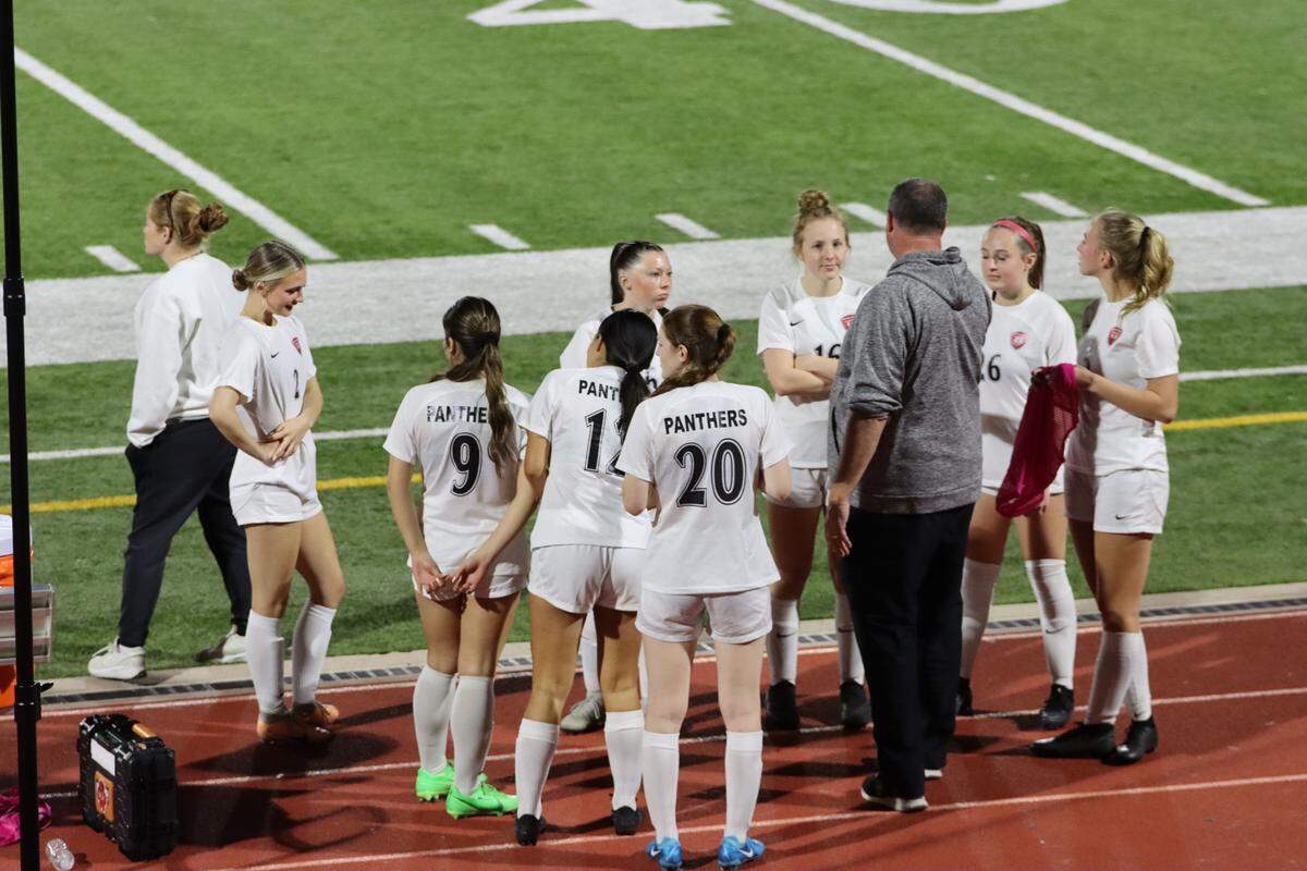 Colleyville Heritage girls soccer head coach Monte Pace talks with his team during a district game at Denton High School in Denton, Texas on Friday, Feb. 28, 2025.