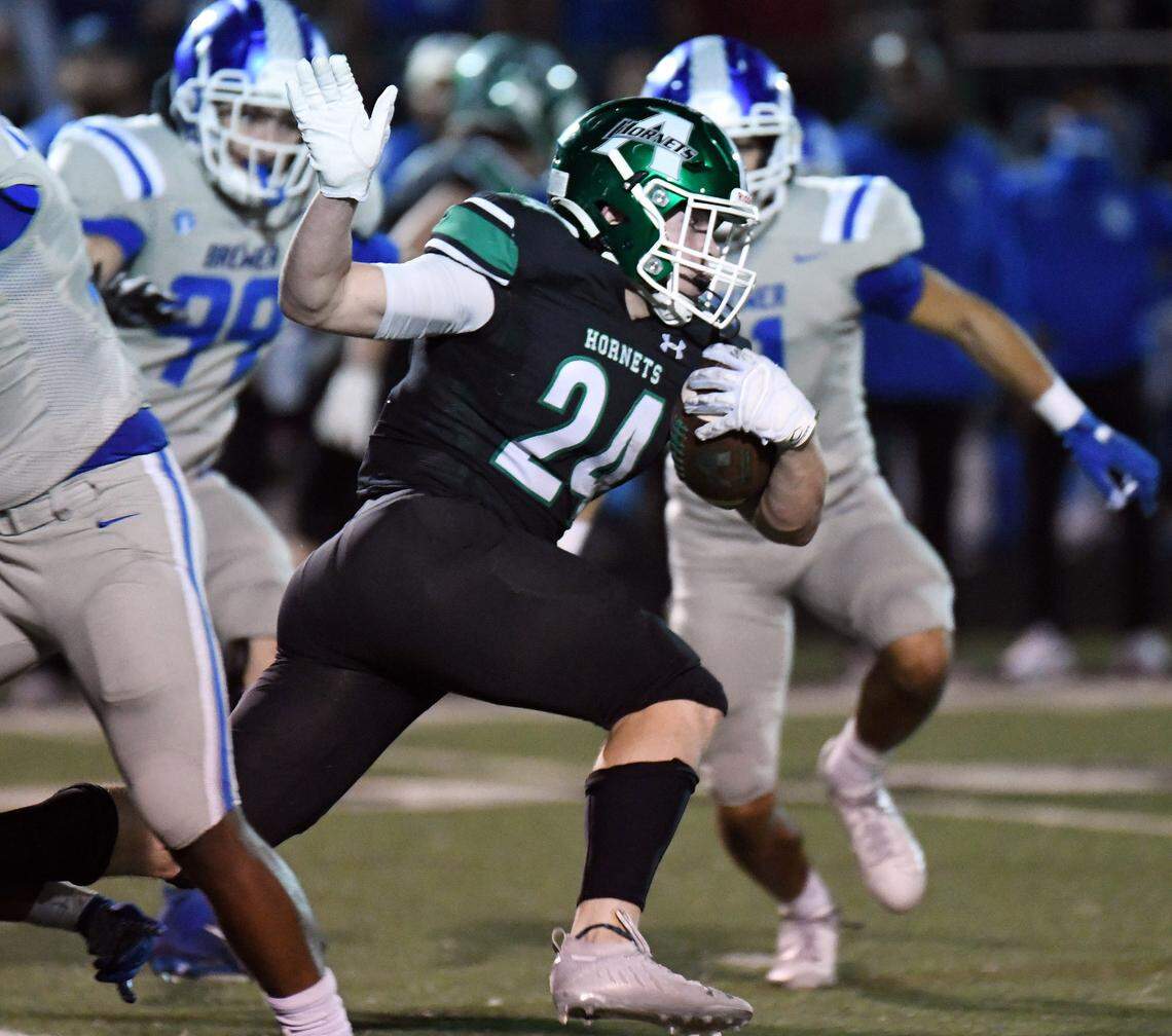 Azle’s Mason Wyble, center races for a first down past Brewer’s Ryan Winham, left and Terrence Durham in the second quarter of their district 3-5A Division 1 football game Friday, October 22, 2021 at Hornet Stadium in Azle, Texas. Special/Bob Haynes