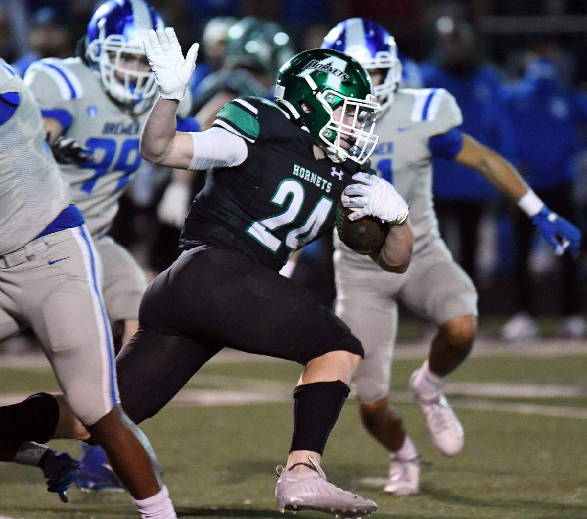 Azle’s Mason Wyble, center races for a first down past Brewer’s Ryan Winham, left and Terrence Durham in the second quarter of their district 3-5A Division 1 football game Friday, October 22, 2021 at Hornet Stadium in Azle, Texas. Special/Bob Haynes