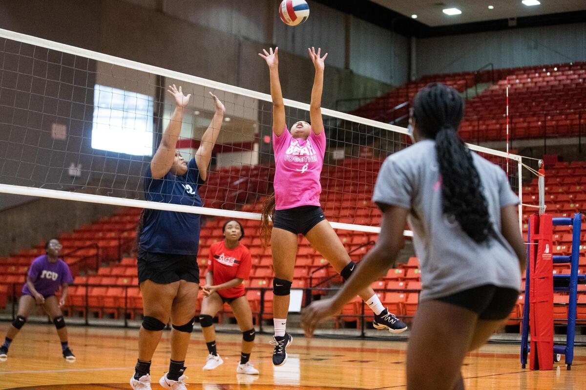 Kassidy Garcia jumps up to set the ball during a Young Women’s Leadership Academy volleyball practices before the team heads to playoffs for the first time Oct. 20, 2021, at Wilkerson-Greines Activity Center in Fort Worth. The team doesn’t have a home court and has to commute more than 10 minutes to the district court.