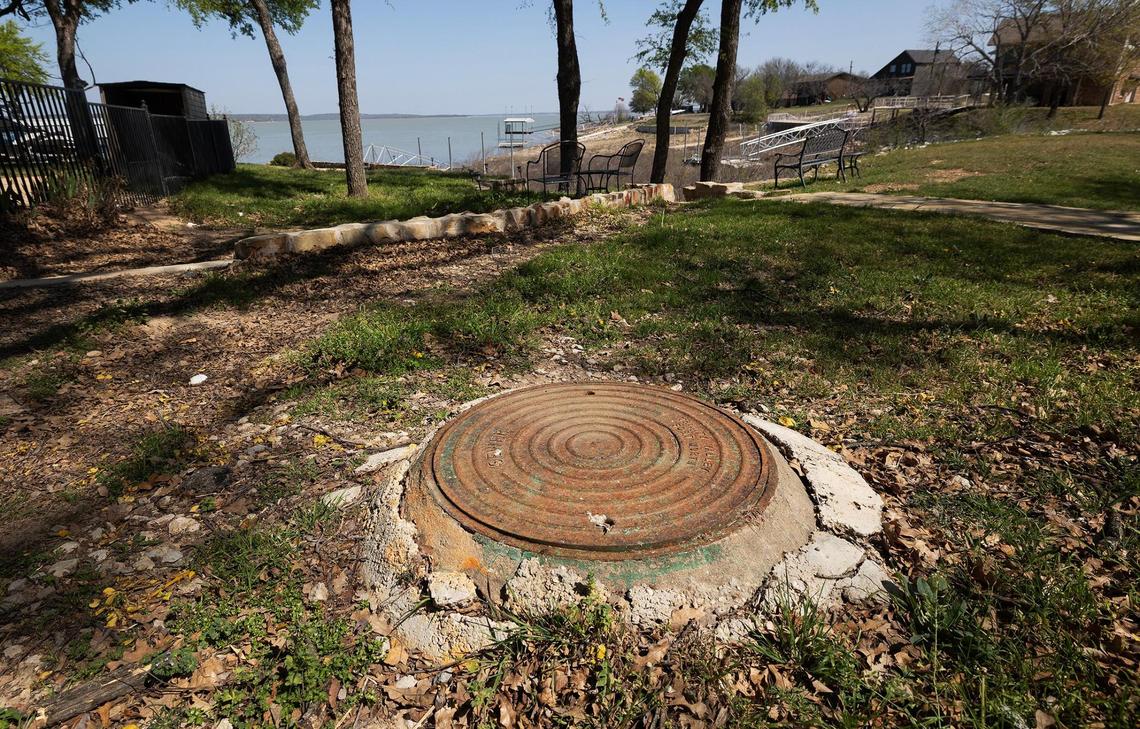 A sewer manhole is located on Richard Rosprim property in Runaway Bay as seen on Tuesday, March 25, 2025. Heavy rains in May and June of 2022 caused sewage to overflow and run into nearby Lake Bridgeport.