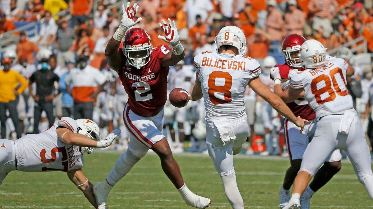 Oklahoma linebacker David Ugwoegbu (2) blocks a punt by Texas punter Ryan Bujcevski (8) during an NCAA college football game in Dallas, Saturday, Oct. 10, 2020. (AP Photo/Michael Ainsworth)
