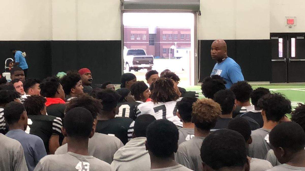 Arlington Seguin head coach Joe Gordon address his team following practice.