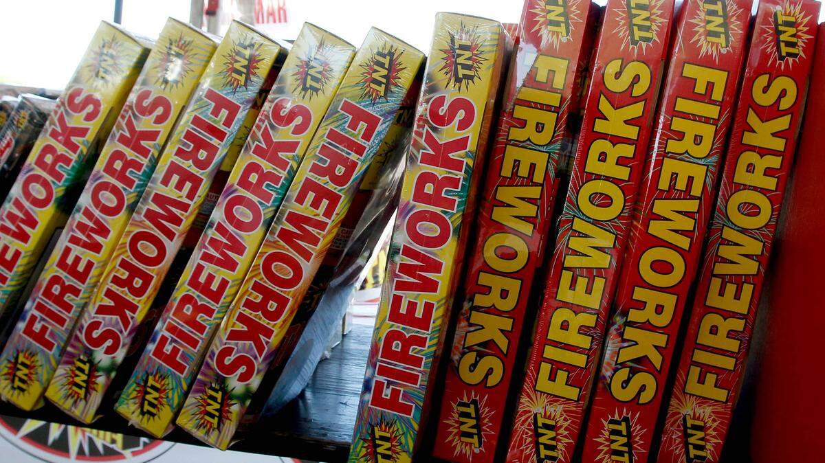 A worker at a fireworks booth in Travis County, Texas, fired at armed suspects accused of robbing the stand, police reported.
