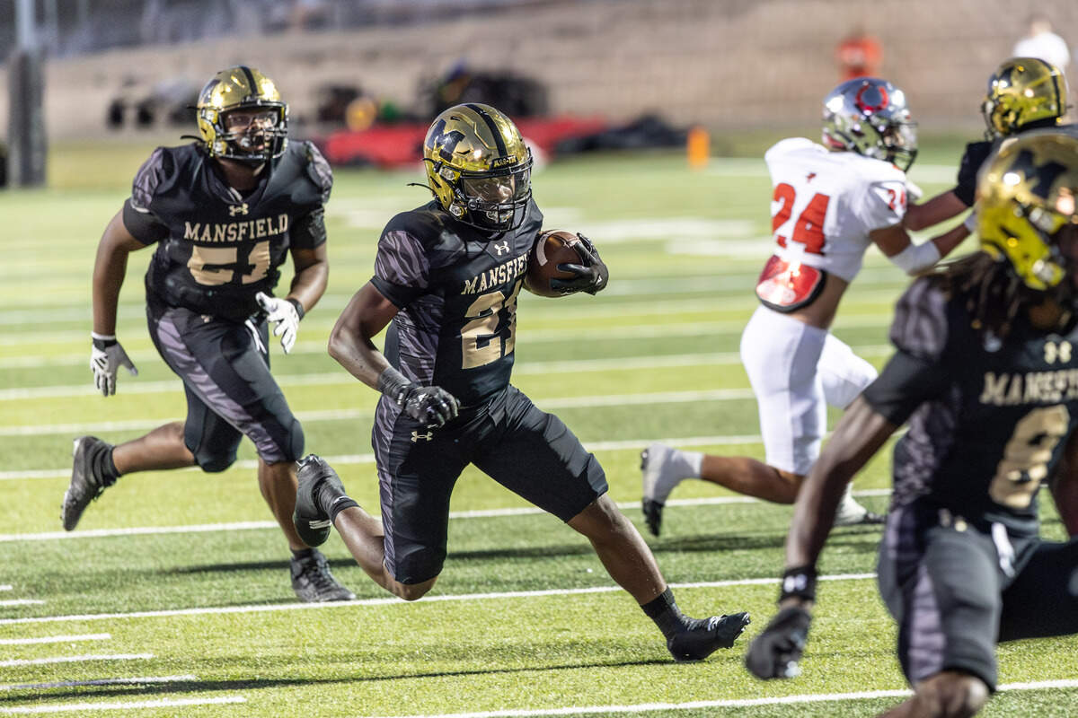 Mansfield running back Raymond Weaver follows a blocker In Friday’s game at Vernon Newsom Stadium. Special to the Star-Telegram / Tom Marvin