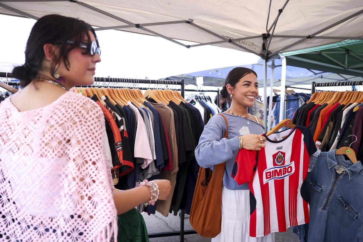 Sisters Abigail and Nathaly Quintanilla shop the Rock 'n' Roll Rummage Sale on South Main Street on Saturday, April 25, 2026 in Fort Worth, Texas. Vendors selling original art, vintage items and handmade goods filled nearby streets.