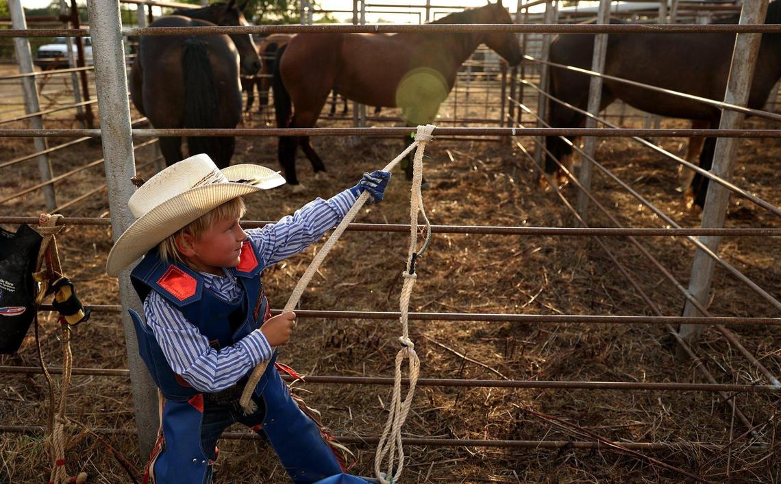 Axton Rabe, 6, of Cooper, Texas, prepares for the mutton busting competition at the Wolfe City Rodeo on Friday, Aug. 5, 2022. Rabe has been mutton busting for two years.