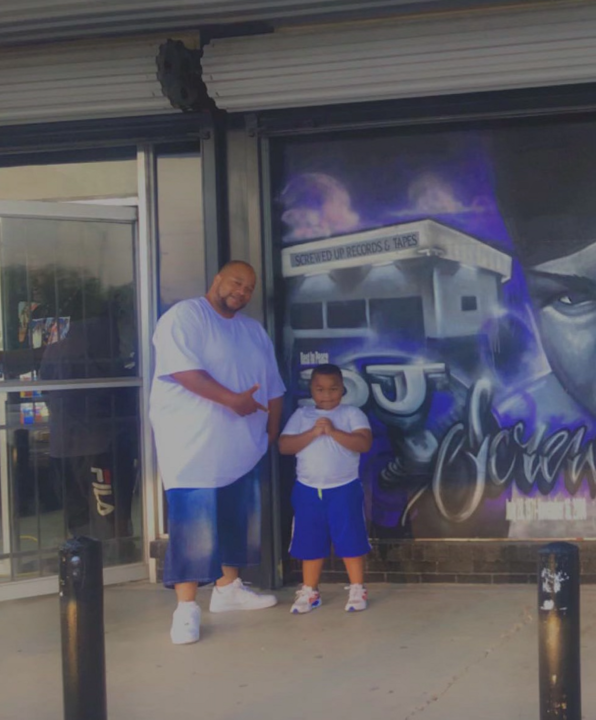 Quintus Record (left) poses with his grandson. Record would often go to his grandson’s football games, family members said, and was a supportive father of four.