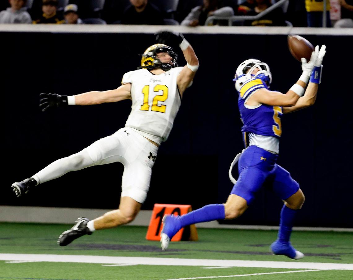 Brock wide receiver Tyler Butler (5) can not come up with the catch on the five yard line defended by Malakoff linebacker Rylan Smith (12) during the first half of a UIL Conference 3A Division 1 semifinal playoff football game at The Ford Center in Frisco, Texas, Thursday, Dec. 07, 2023.