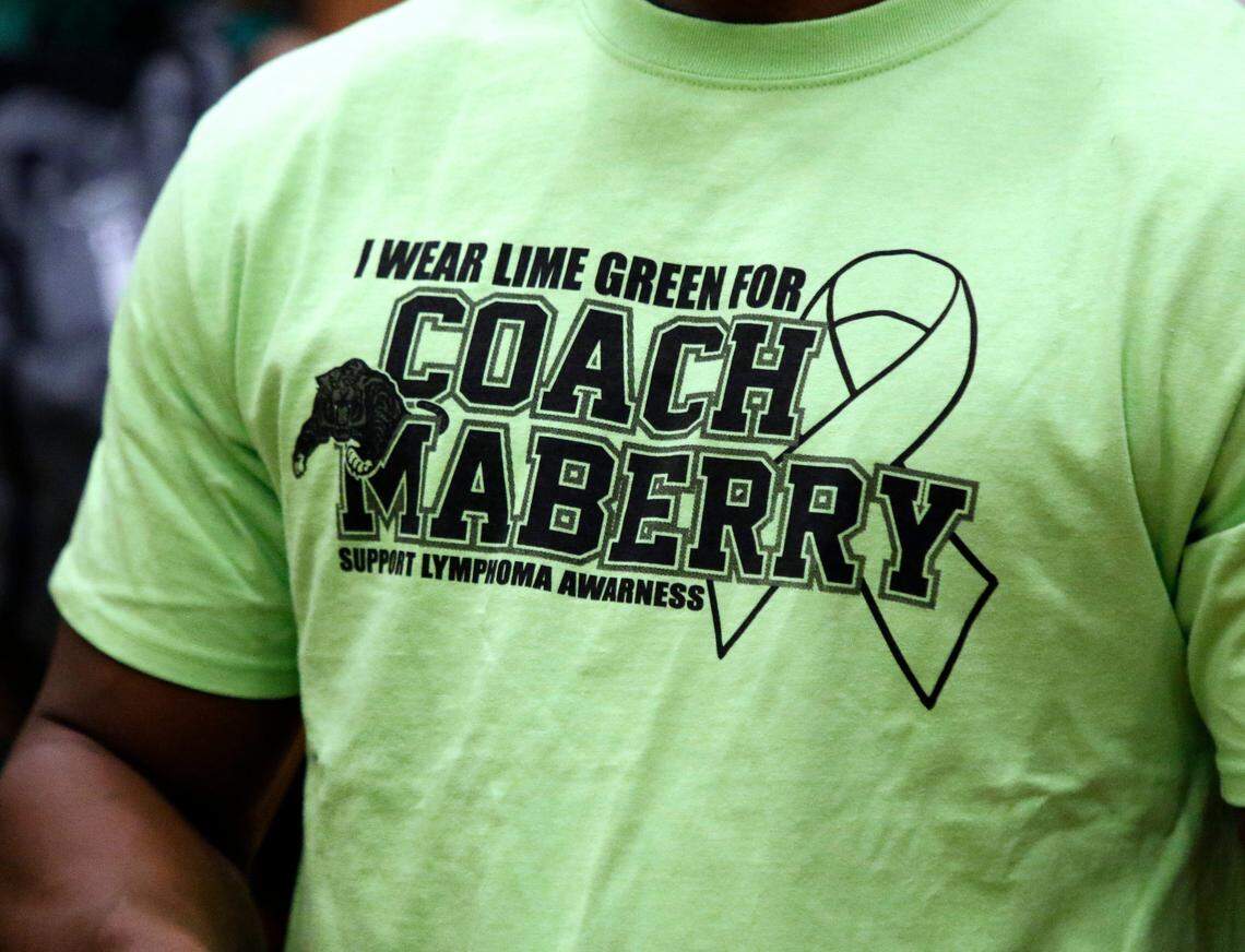 Coaches wore lime green t-shirts to honor head football coach Daniel Maberry during a high school basketball game at Mansfield High School in Mansfield, Texas, Friday, Feb. 07, 2020. (Special to the Star-Telegram Bob Booth)