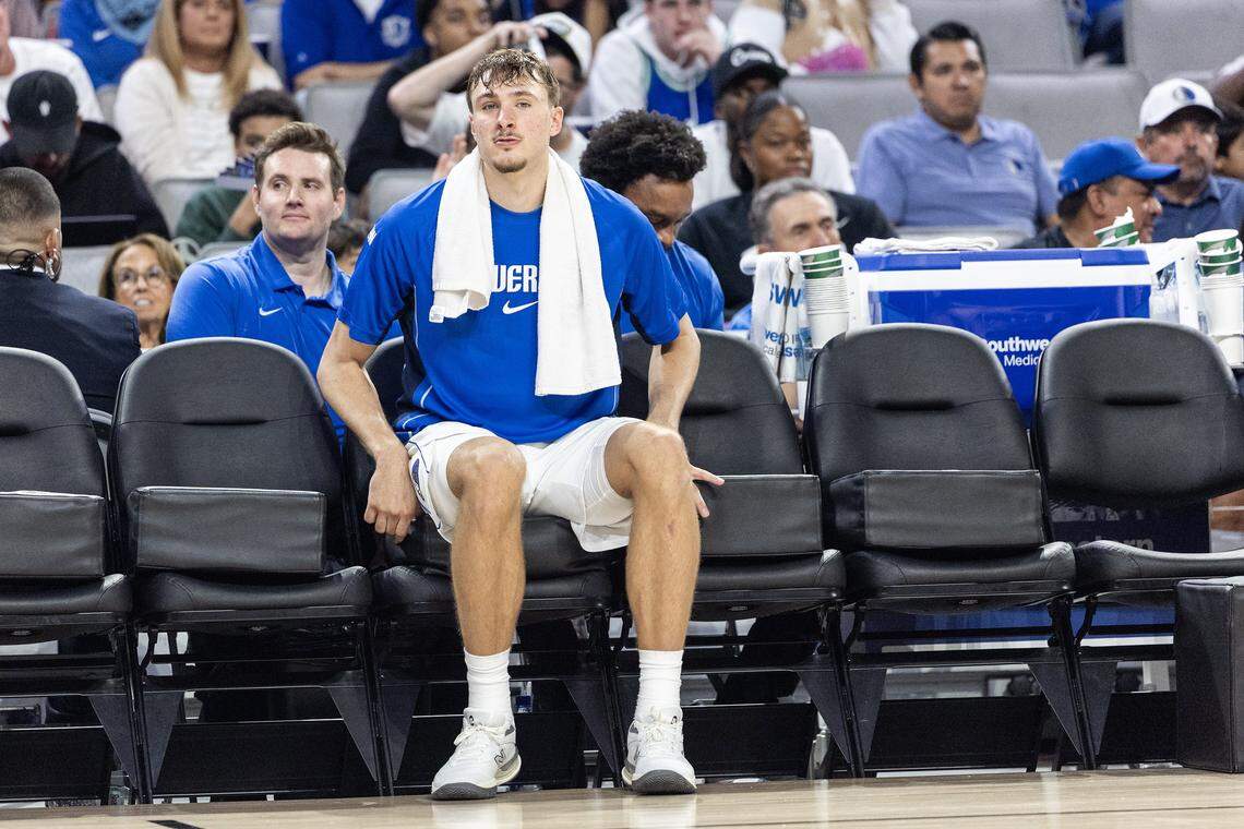 Mavericks forward Cooper Flagg (32) sits alone on the bench in the second half of a preseason NBA game between the Dallas Mavericks and Oklahoma City Thunder at Dickies Arena in Fort Worth on Monday, Oct. 6, 2025.