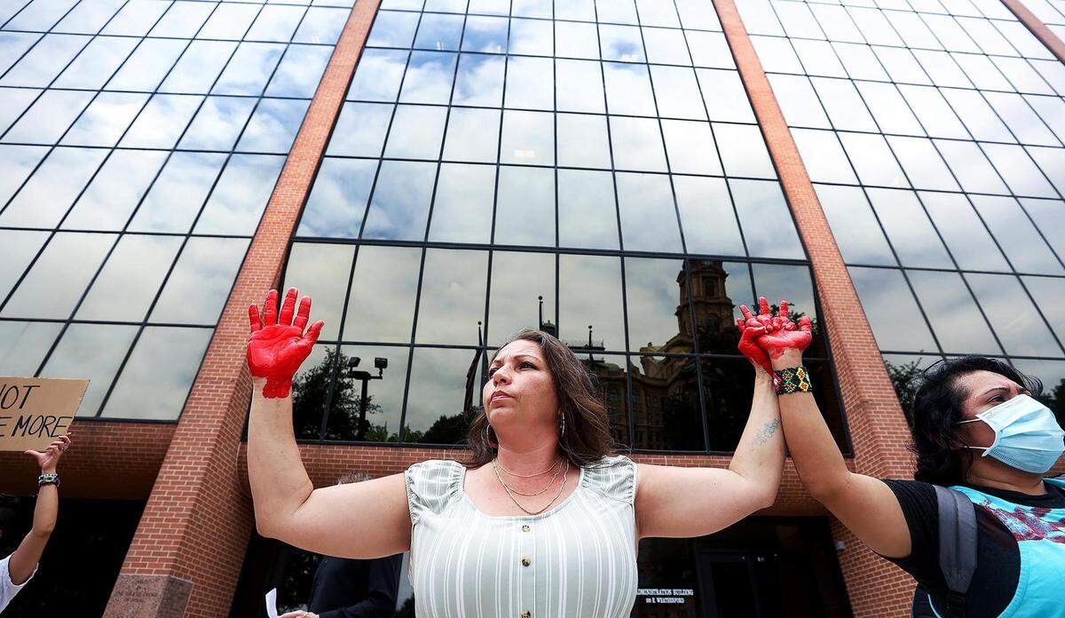 Kristina Salinas stands outside the Tarrant County Court of Commissioners meeting to demand changes at the Tarrant County Jail during a rally on Tuesday, May 10, 2022, in Fort Worth. Salinas’ sister, Kelly Masten, is still in a coma following a 10 day stay in the jail in April.