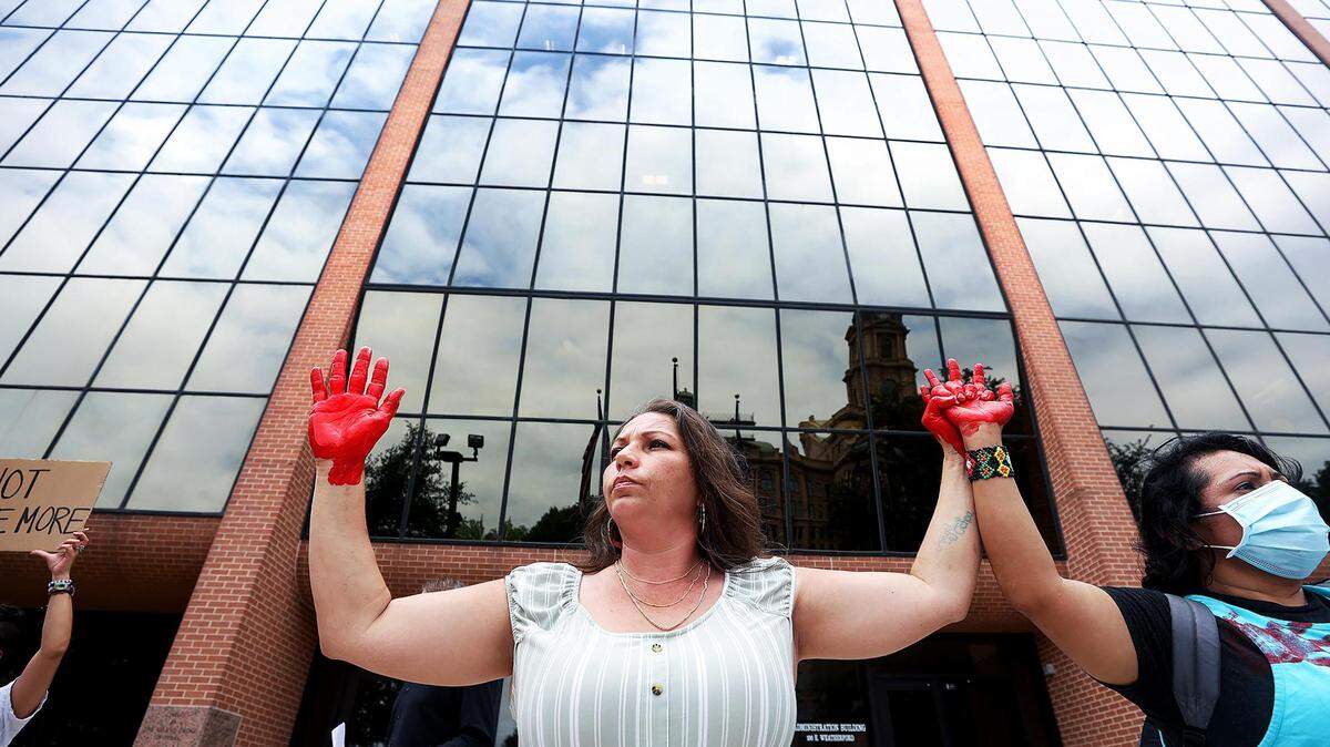 Kristina Salinas stands outside the Tarrant County Court of Commissioners meeting to demand changes at the Tarrant County Jail during a rally in May. Salinas’ sister was in a coma following a 10-day stay in the jail in April.