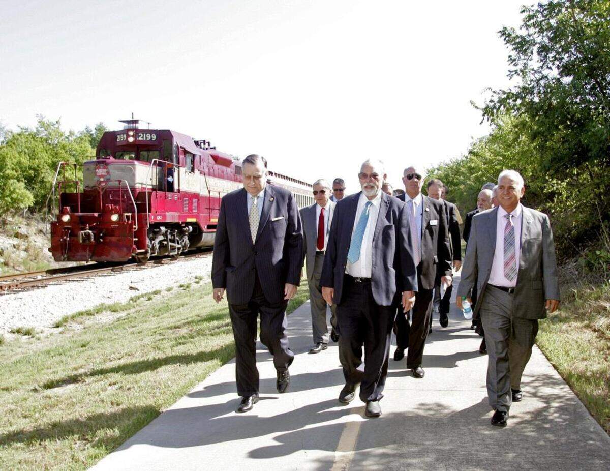 (center and right) Grapevine mayor William Tate and North Richland Hills mayor Oscar Trevino along with other dignitaries walk from the train to ground breaking ceremonies for the Tex Rail passenger service in North Richland Hills Wednesday morning Aug. 24, 2016. The service is expected to begin in 2018.(Special to the Star-Telegram Bob Booth)